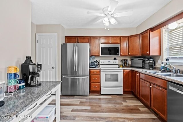 1376 Darlene Ct, Radcliff, KY 40160 - kitchen featuring appliances with stainless steel finishes, a ceiling fan, brown cabinets, and light wood-style flooring
