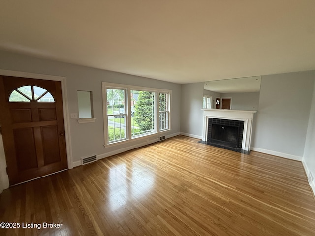 230 Tyne Rd, Louisville, KY 40207 - unfurnished living room featuring wood finished floors and a tile fireplace