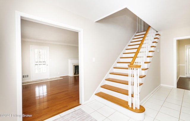 8613 Whipps Bend Rd, Bellemeade, KY 40222 - stairway featuring crown molding, tile patterned floors, and a fireplace with flush hearth