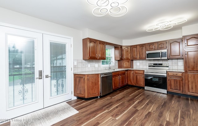 8613 Whipps Bend Rd, Bellemeade, KY 40222 - kitchen featuring appliances with stainless steel finishes, french doors, light countertops, dark wood-style floors, and backsplash