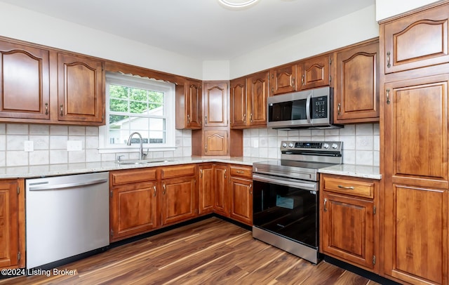 8613 Whipps Bend Rd, Bellemeade, KY 40222 - kitchen featuring appliances with stainless steel finishes, dark wood-style flooring, brown cabinetry, and tasteful backsplash