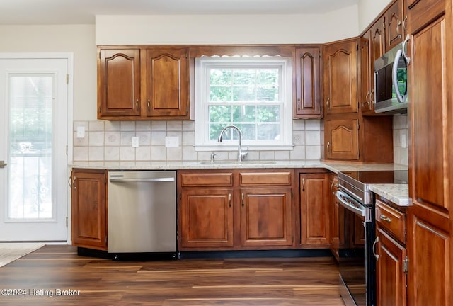8613 Whipps Bend Rd, Bellemeade, KY 40222 - kitchen featuring stainless steel appliances, tasteful backsplash, light stone countertops, and brown cabinets