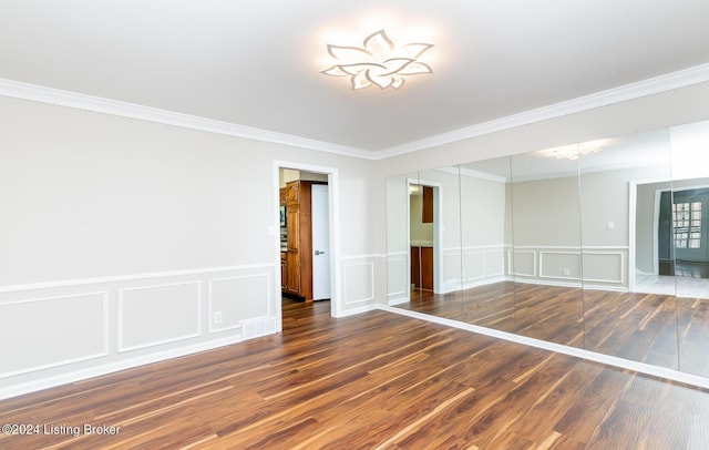 8613 Whipps Bend Rd, Bellemeade, KY 40222 - empty room with a decorative wall, ornamental molding, wood finished floors, and wainscoting