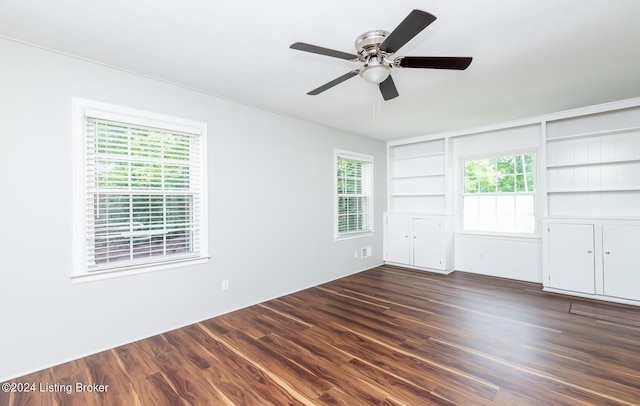 8613 Whipps Bend Rd, Bellemeade, KY 40222 - empty room with ceiling fan, built in shelves, plenty of natural light, and dark wood-style floors