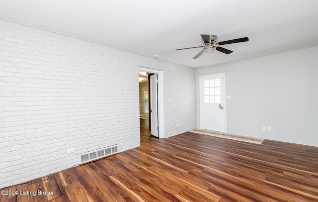 8613 Whipps Bend Rd, Bellemeade, KY 40222 - empty room with brick wall, a ceiling fan, and dark wood-style flooring