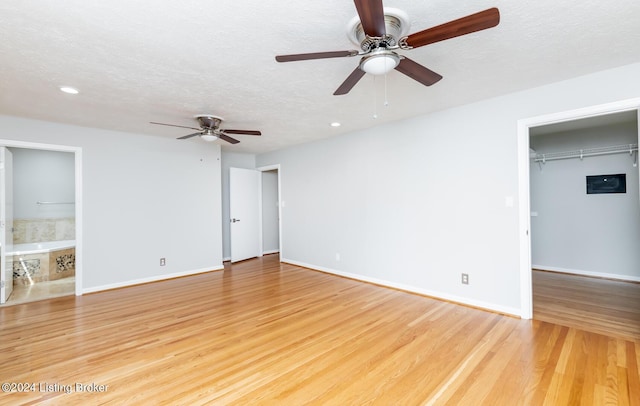 8613 Whipps Bend Rd, Bellemeade, KY 40222 - unfurnished bedroom with light wood-style floors, recessed lighting, a walk in closet, a textured ceiling, and a closet