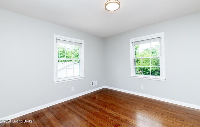 8613 Whipps Bend Rd, Bellemeade, KY 40222 - empty room with healthy amount of natural light and dark wood finished floors