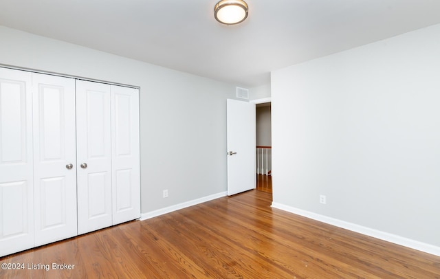 8613 Whipps Bend Rd, Bellemeade, KY 40222 - unfurnished bedroom with wood finished floors and a closet