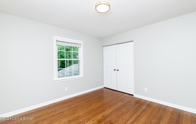 8613 Whipps Bend Rd, Bellemeade, KY 40222 - unfurnished bedroom featuring wood finished floors and a closet