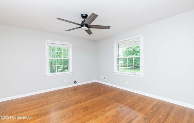 8613 Whipps Bend Rd, Bellemeade, KY 40222 - empty room with plenty of natural light, wood finished floors, and ceiling fan