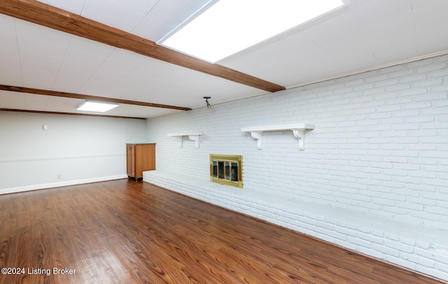 8613 Whipps Bend Rd, Bellemeade, KY 40222 - unfurnished living room featuring a fireplace, dark wood-style flooring, brick wall, and beam ceiling