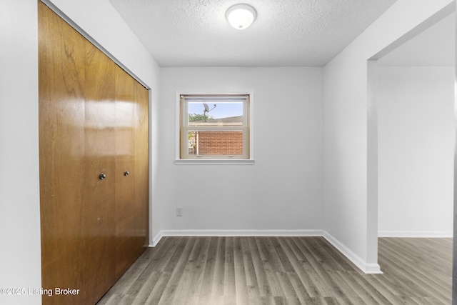 6325 Hackberry Way, Louisville, KY 40229 - unfurnished bedroom with a closet, wood finished floors, and a textured ceiling
