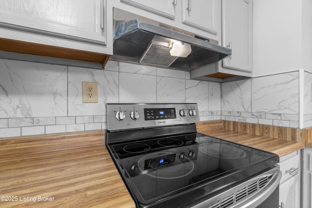 6325 Hackberry Way, Louisville, KY 40229 - kitchen with stainless steel electric range, under cabinet range hood, backsplash, butcher block countertops, and white cabinets