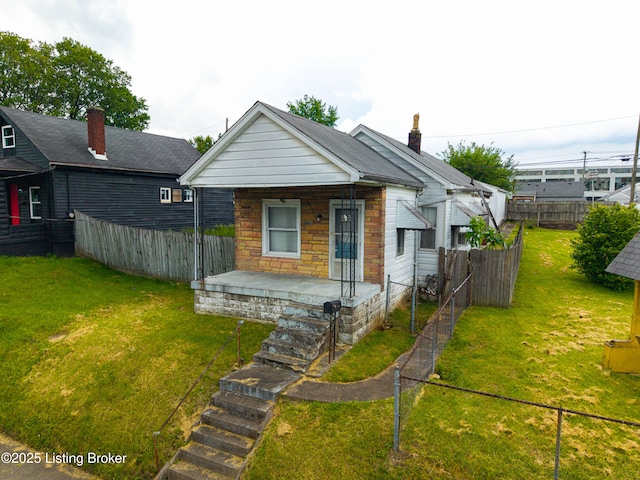 1730 W Gaulbert Ave, Louisville, KY 40210 - shotgun-style home featuring a porch and a fenced backyard