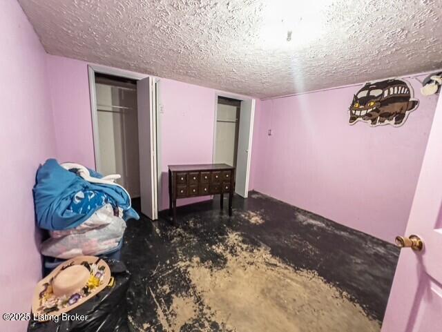 2866 Sunbeam Rd, Leitchfield, KY 42754 - bedroom featuring a textured ceiling and concrete floors
