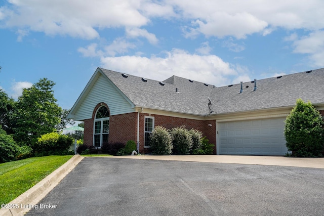 1003 Persimmon Pl, La Grange, KY 40031 - view of front of house featuring brick siding, a shingled roof, driveway, and an attached garage