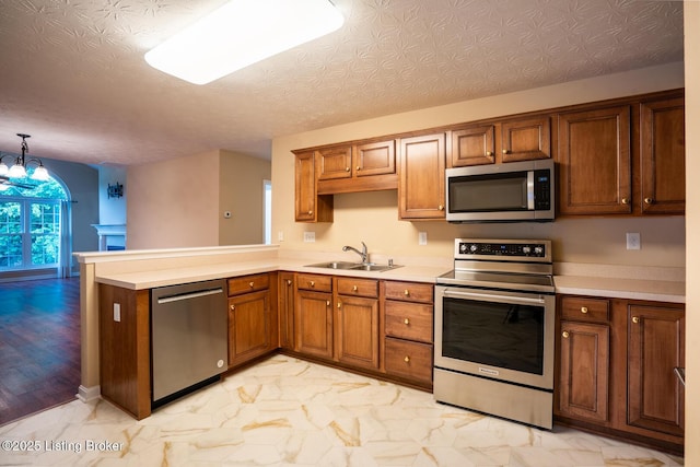 1003 Persimmon Pl, La Grange, KY 40031 - kitchen with stainless steel appliances, brown cabinets, and a peninsula