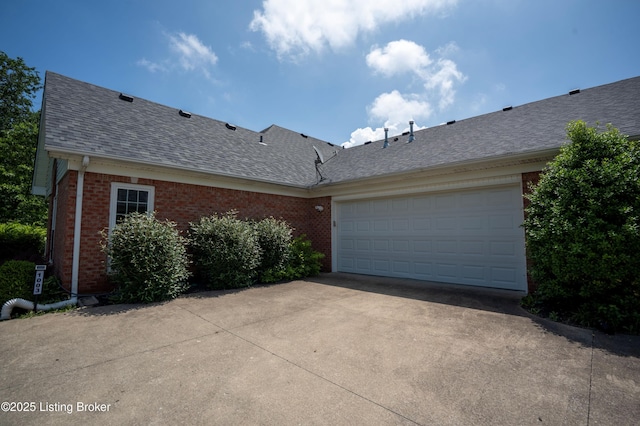 1003 Persimmon Pl, La Grange, KY 40031 - view of side of property with roof with shingles, brick siding, driveway, and an attached garage