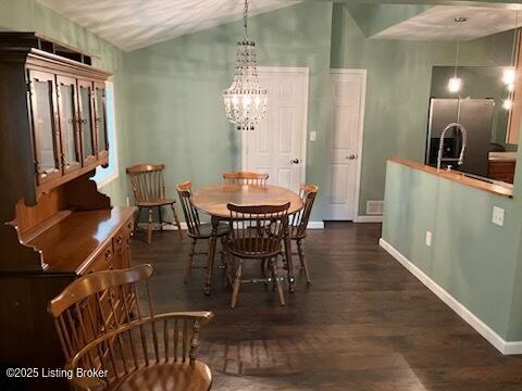 1102 W Hebron Ln, Shepherdsville, KY 40165 - dining area with wood finished floors, a chandelier, and vaulted ceiling