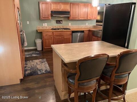1102 W Hebron Ln, Shepherdsville, KY 40165 - kitchen featuring appliances with stainless steel finishes, under cabinet range hood, dark wood-type flooring, and light countertops