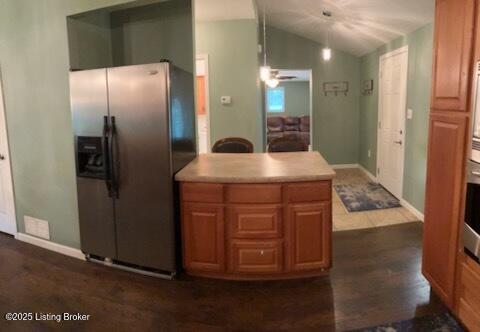 1102 W Hebron Ln, Shepherdsville, KY 40165 - kitchen featuring stainless steel fridge, lofted ceiling, light countertops, dark wood-style flooring, and brown cabinetry