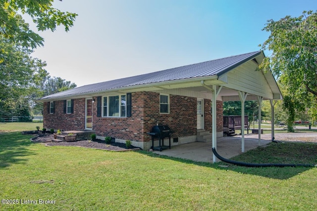 10563 S Dixie Hwy, Sonora, KY 42776 - rear view of property featuring a carport, brick siding, a patio area, a metal roof, and a yard