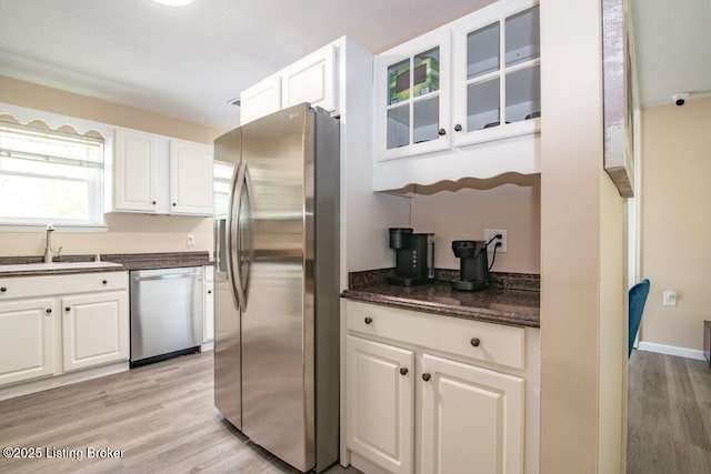 10563 S Dixie Hwy, Sonora, KY 42776 - kitchen featuring stainless steel appliances, light wood-style flooring, white cabinetry, and glass insert cabinets