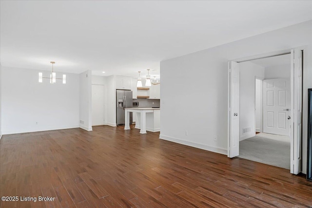5800 Coach Gate Wynde Unit 312D, Louisville, KY 40207 - unfurnished living room with a chandelier and dark wood-style floors
