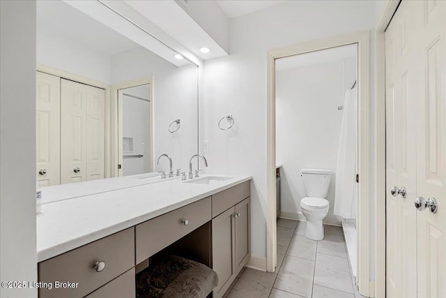 5800 Coach Gate Wynde Unit 312D, Louisville, KY 40207 - bathroom featuring marble look tile flooring, vanity, a closet, and recessed lighting