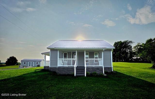 1515 Concord Rd, Falls Of Rough, KY 40119 - bungalow-style house with a porch, a front lawn, and a metal roof