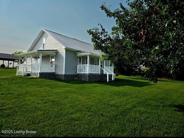 1515 Concord Rd, Falls Of Rough, KY 40119 - view of property exterior with a porch, a lawn, and a metal roof
