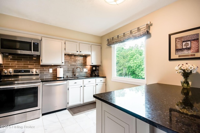 7327 Sideoats Dr, Crestwood, KY 40014 - kitchen featuring stainless steel appliances, tasteful backsplash, and white cabinetry