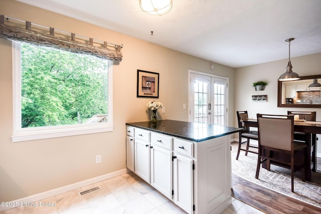 7327 Sideoats Dr, Crestwood, KY 40014 - kitchen featuring a peninsula, white cabinets, dark countertops, pendant lighting, and light marble finish flooring