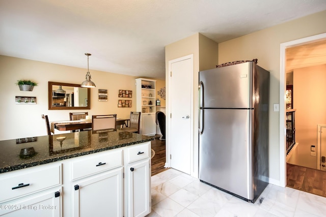 7327 Sideoats Dr, Crestwood, KY 40014 - kitchen featuring freestanding refrigerator, white cabinets, light marble finish floors, and dark stone countertops