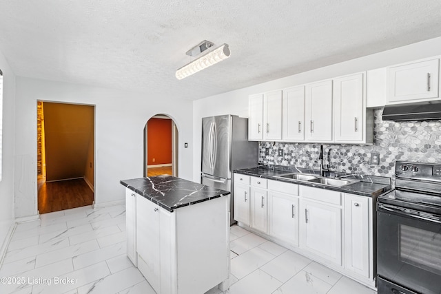 2215 W Jefferson St, Louisville, KY 40212 - kitchen featuring black electric range oven, light marble finish floors, extractor fan, freestanding refrigerator, and a textured ceiling