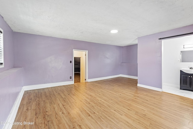 2215 W Jefferson St, Louisville, KY 40212 - spare room featuring light wood-style flooring, a textured ceiling, and recessed lighting
