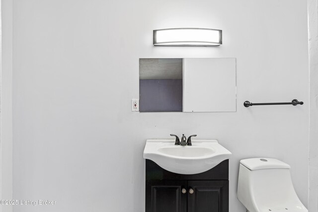 2215 W Jefferson St, Louisville, KY 40212 - half bathroom featuring vanity and toilet