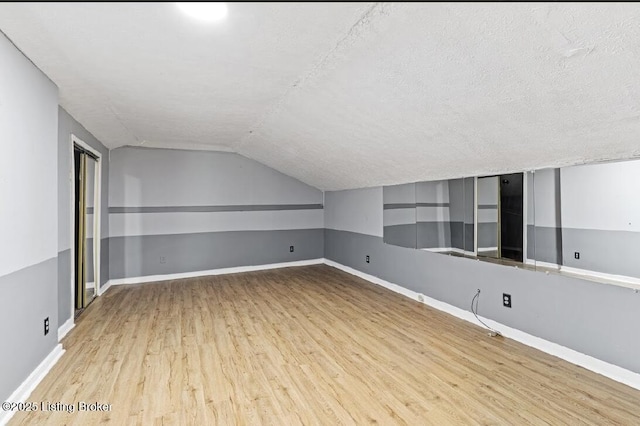2215 W Jefferson St, Louisville, KY 40212 - bonus room featuring wood finished floors, lofted ceiling, and a textured ceiling