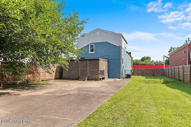 2215 W Jefferson St, Louisville, KY 40212 - back of house featuring a fenced backyard and driveway