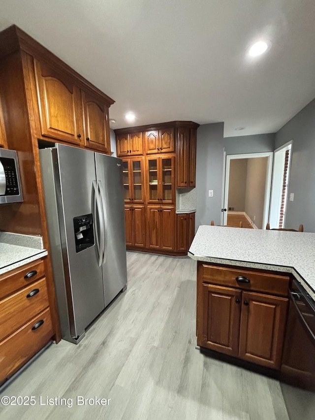 2707 Sharon Way, Louisville, KY 40220 - kitchen featuring stainless steel appliances, light countertops, light wood-style floors, recessed lighting, and brown cabinetry