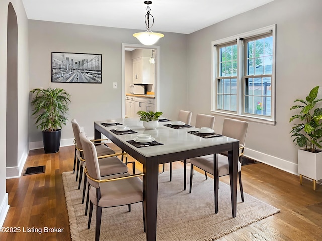 2406 Bradley Ave, Louisville, KY 40217 - dining space featuring wood finished floors and arched walkways