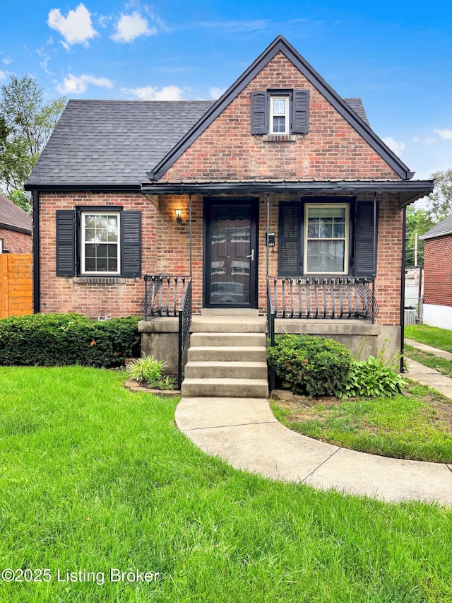 2406 Bradley Ave, Louisville, KY 40217 - view of front of property with brick siding, covered porch, and roof with shingles