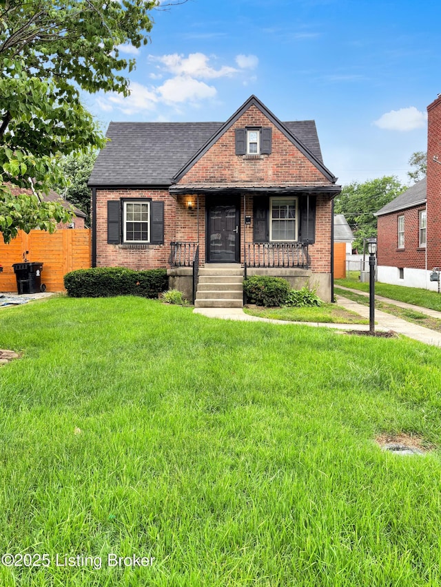 2406 Bradley Ave, Louisville, KY 40217 - view of front of property featuring covered porch, brick siding, and a shingled roof