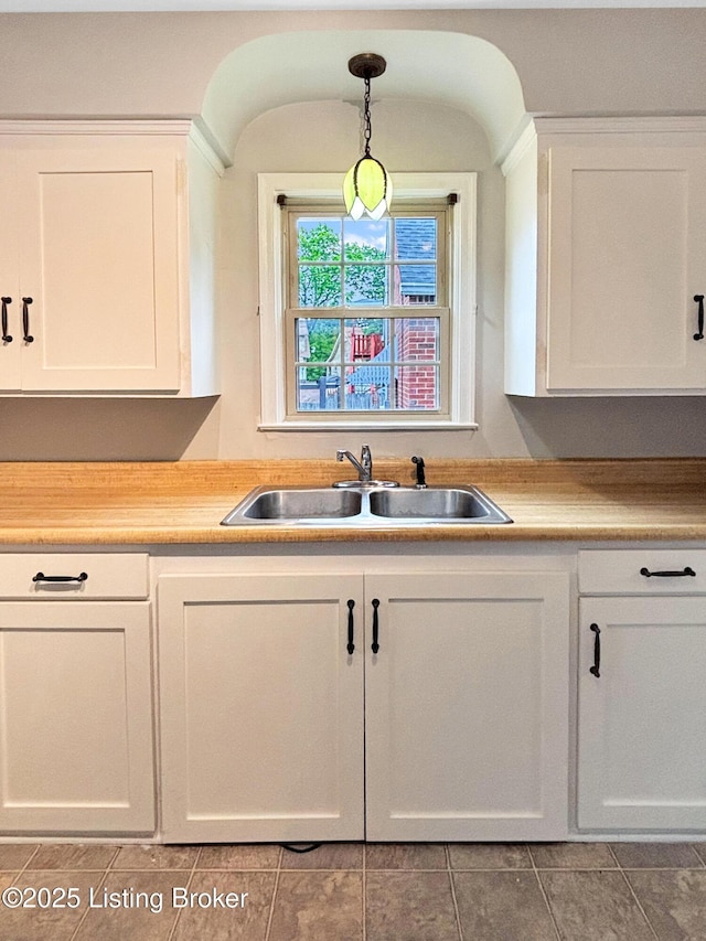 2406 Bradley Ave, Louisville, KY 40217 - kitchen featuring white cabinetry, hanging light fixtures, tile patterned flooring, and light countertops