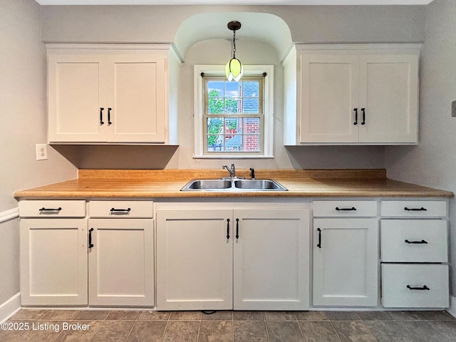 2406 Bradley Ave, Louisville, KY 40217 - kitchen with white cabinetry, hanging light fixtures, and light countertops