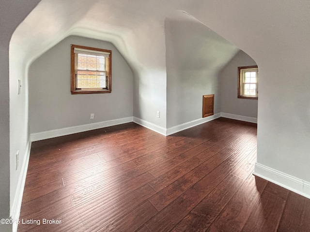 2406 Bradley Ave, Louisville, KY 40217 - additional living space featuring dark wood-type flooring, vaulted ceiling, plenty of natural light, and arched walkways