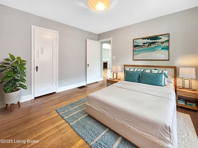2406 Bradley Ave, Louisville, KY 40217 - bedroom featuring wood finished floors and arched walkways