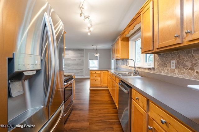 7210 River Rd, Prospect, KY 40059 - kitchen featuring stainless steel appliances, dark wood-type flooring, backsplash, brown cabinets, and decorative light fixtures