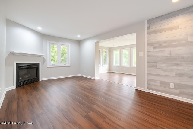 7210 River Rd, Prospect, KY 40059 - unfurnished living room with healthy amount of natural light, recessed lighting, dark wood-style flooring, and a glass covered fireplace