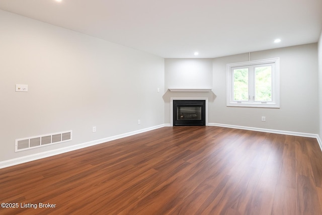7210 River Rd, Prospect, KY 40059 - unfurnished living room featuring a glass covered fireplace, dark wood-style flooring, and recessed lighting